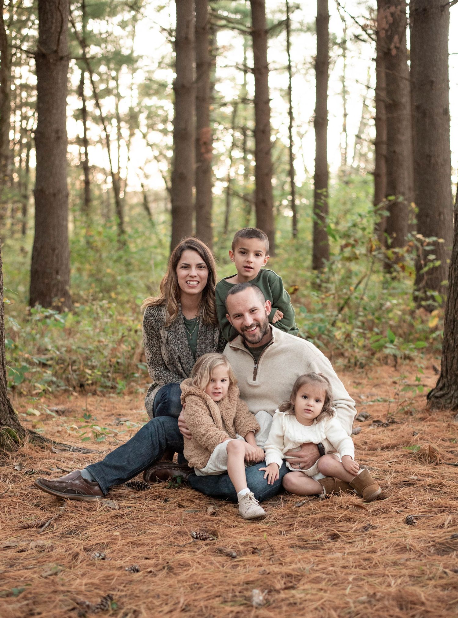 A cute family of five having fun in the forest by St. Louis Photographer Isabel Nolan.