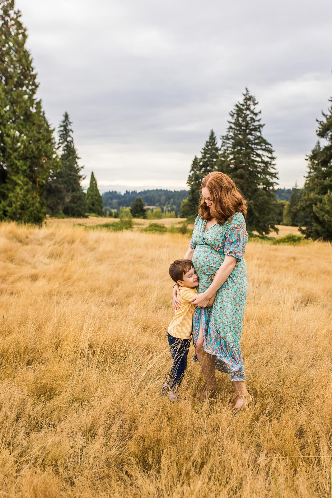 Son hugging his mother in a grassy field in Woodinville