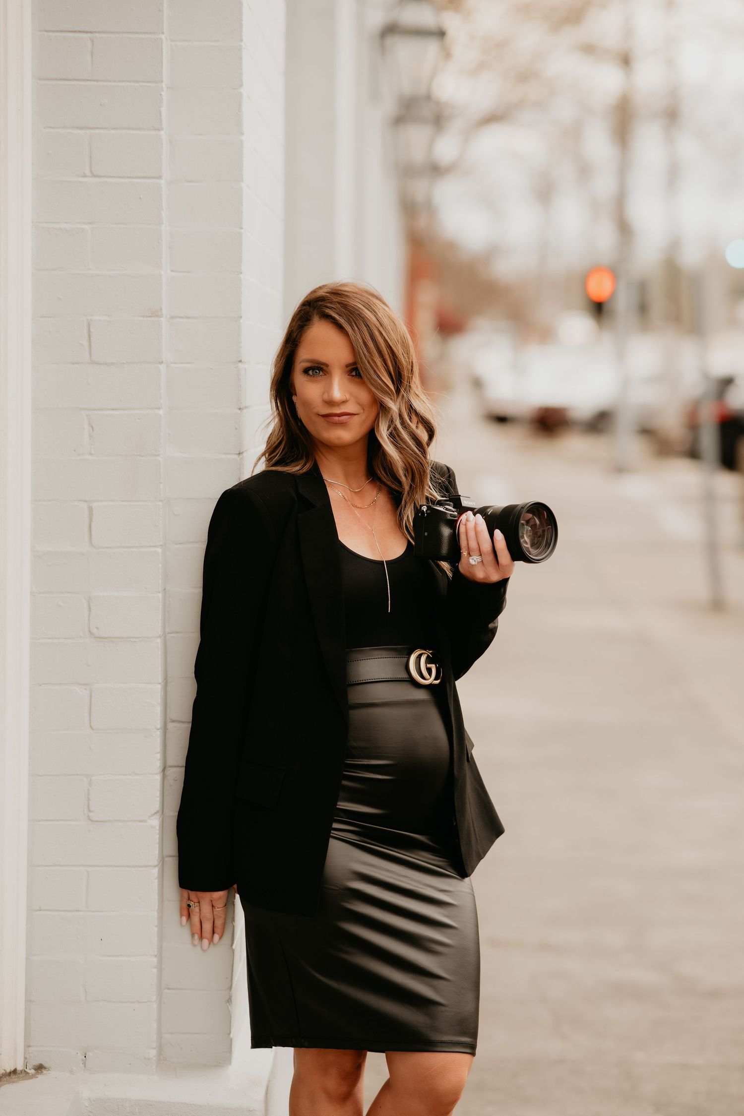 A beautiful woman, the photographer, showing her lens where she makes all her magic.