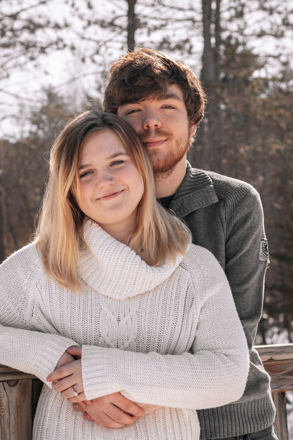 Cozy winter couple photos showing embraces while wearing knit sweaters outdoors.