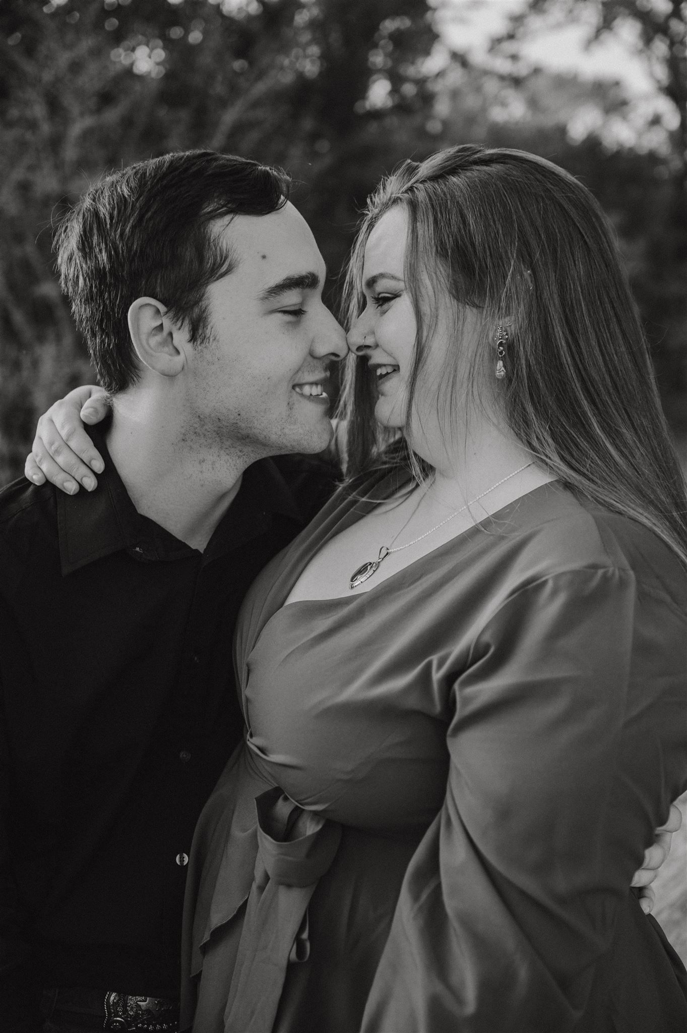 Intimate black and white portrait of a couple sharing a tender moment.