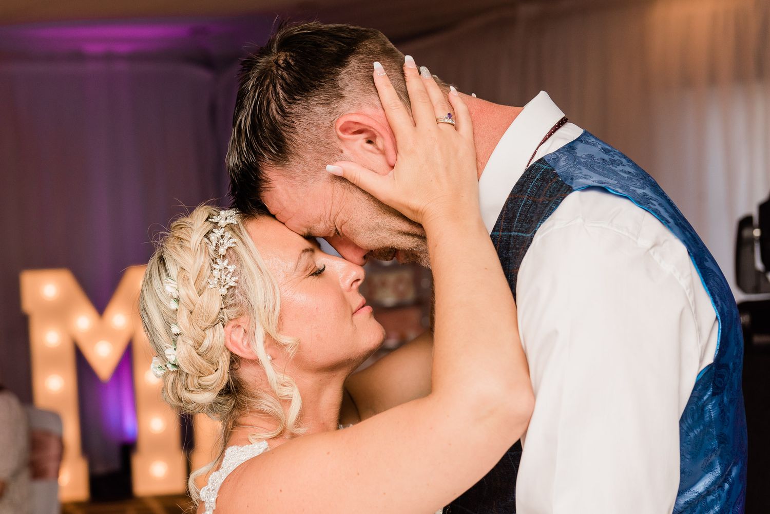 Bride and groom share an emotional moment during the 1st dance