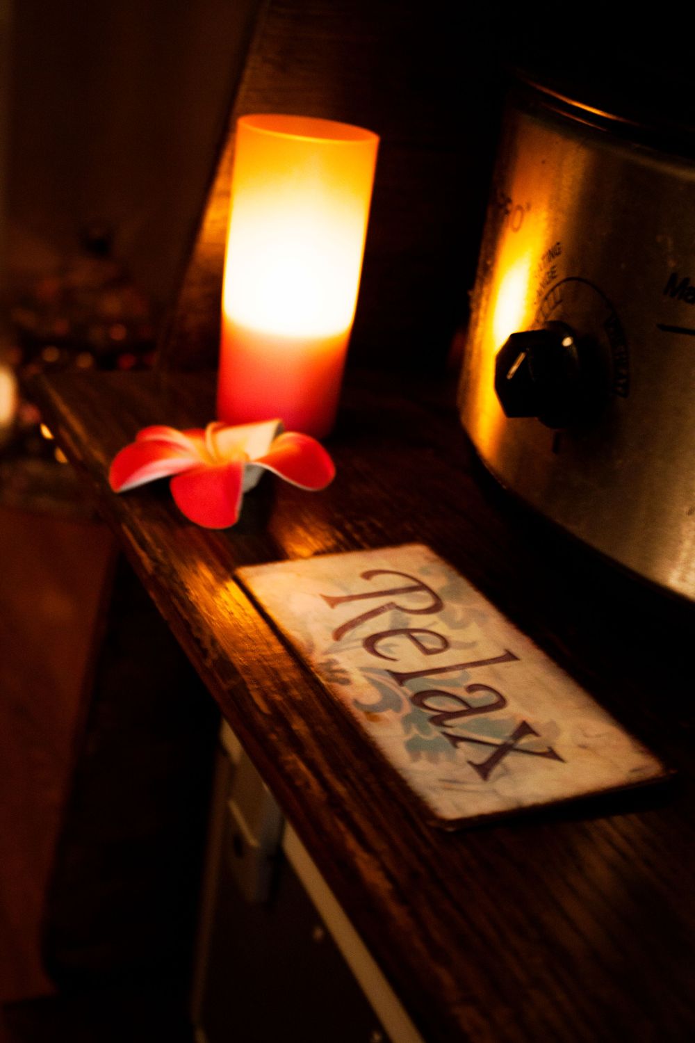 Glowing candles illuminate in Spa setting.