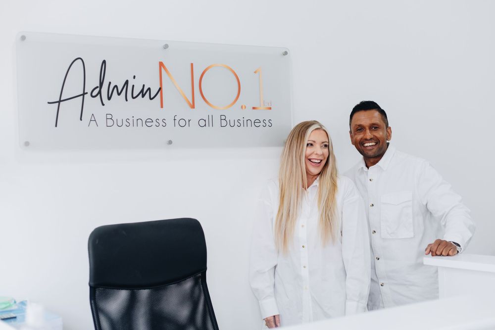 Two professionals standing under Admin NO.1 business sign in modern office.