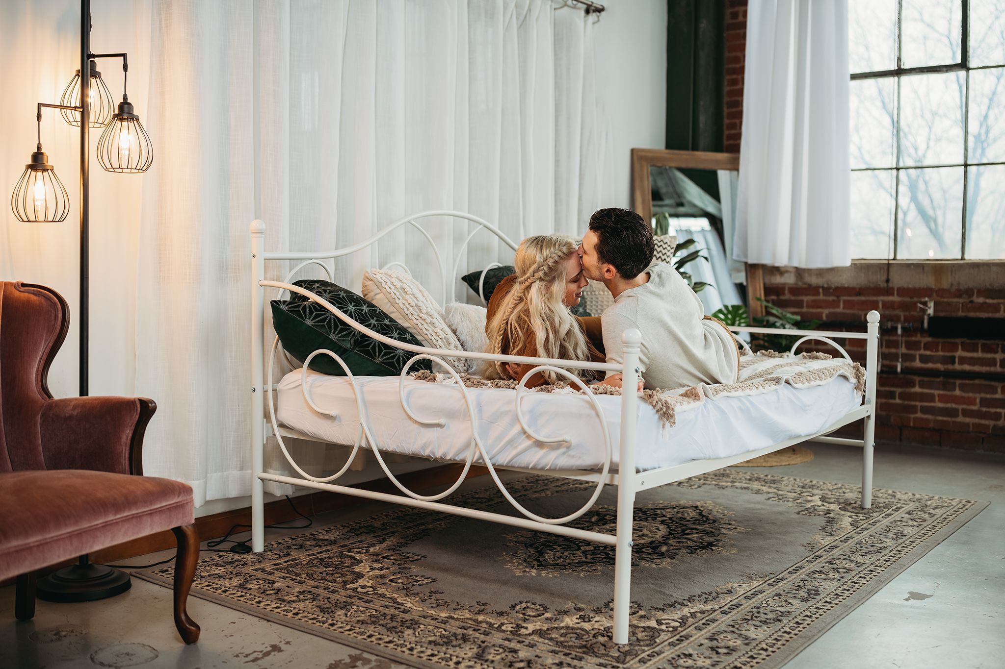 Engaged couple snuggling on a daybed in Akron Ohio captured by Jessica Hepp Photography