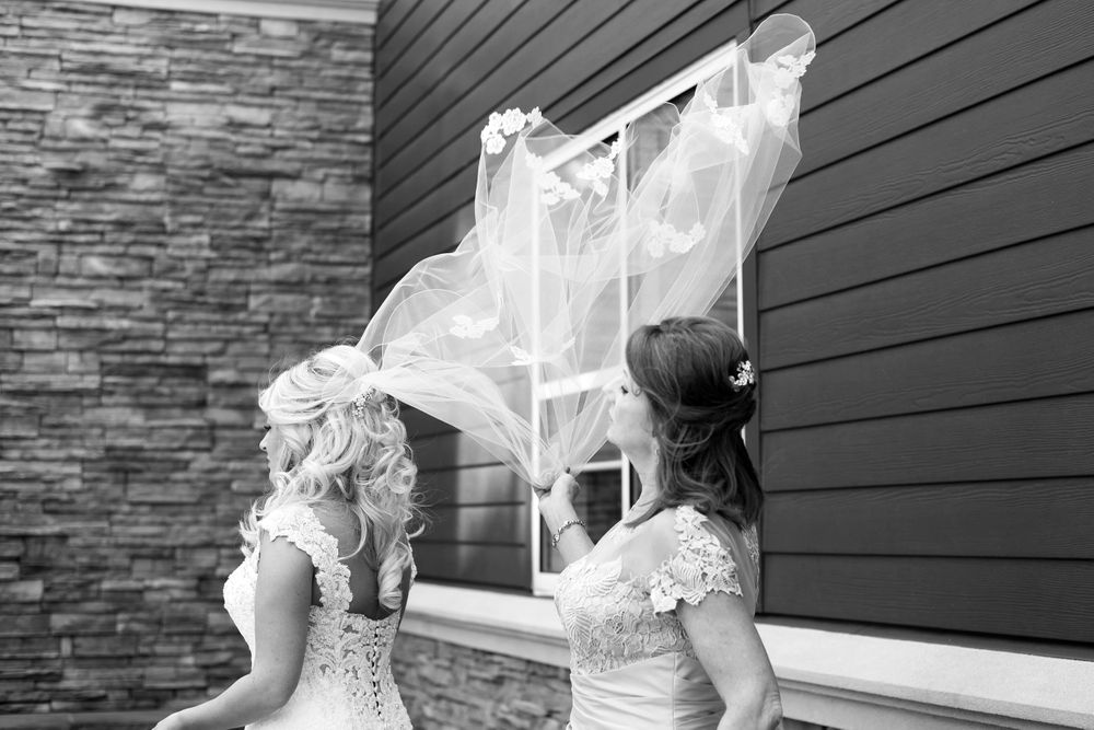 Bride's veil catches the wind on her wedding day in Cleveland, Ohio.
