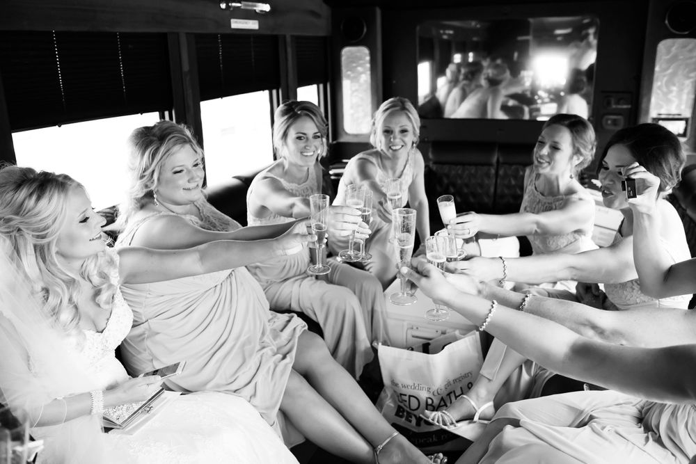 Bridesmaids make a toast to bride on way to wedding ceremony in Cleveland, Ohio.