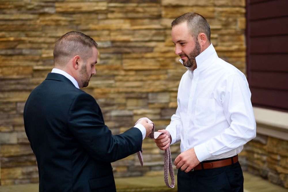 Best man helps groom before wedding in Cleveland, Ohio.