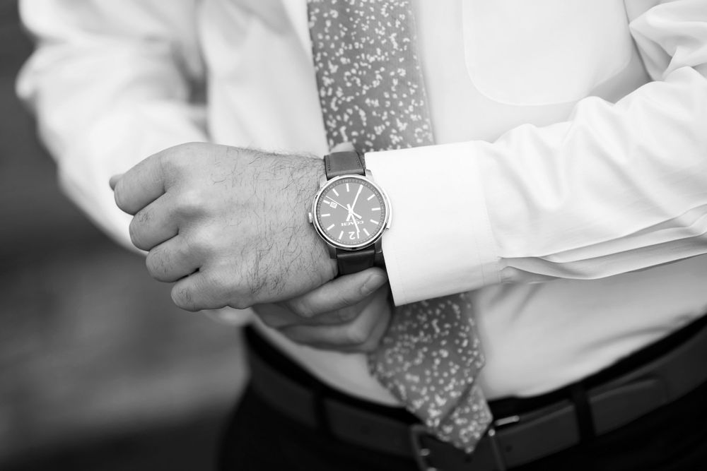Groom adjusts watch before wedding ceremony in Cleveland, Ohio.