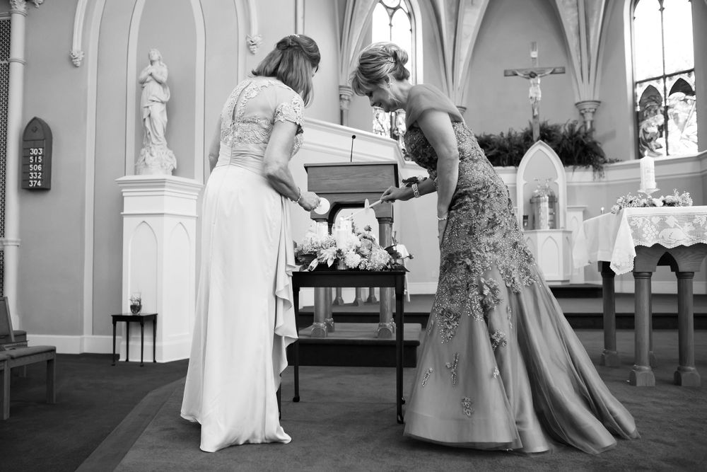 Mother light unity candle during wedding ceremony at Saint Mary Parish in Elyria, Ohio.