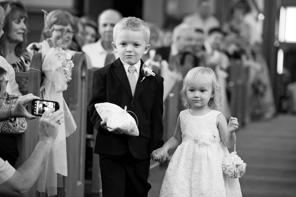 Ring bearer and flower girl during wedding ceremony at Saint Mary Parish in Elyria, Ohio.