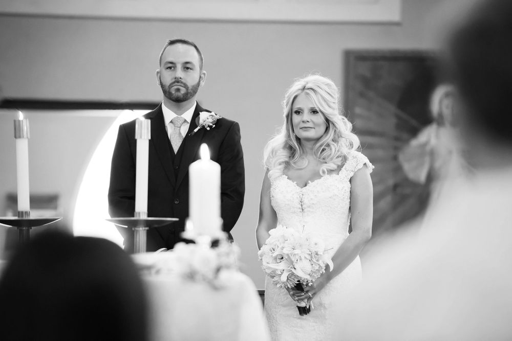 Bride and groom listen to homily during wedding ceremony at Saint Mary Parish in Elyria, Ohio.