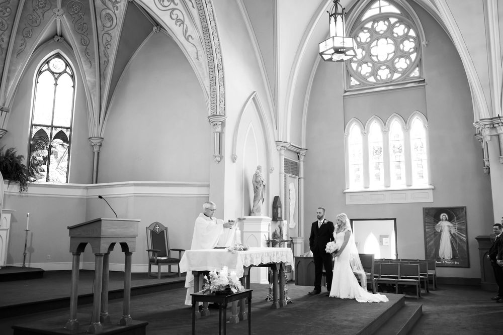 Priest prepares communion during wedding ceremony at Saint Mary Parish in Elyria, Ohio.
