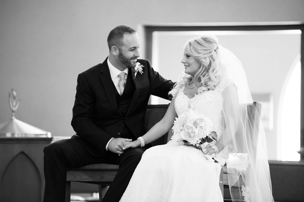 Bride and groom interact during ceremony at Saint Mary Parish in Elyria, Ohio.