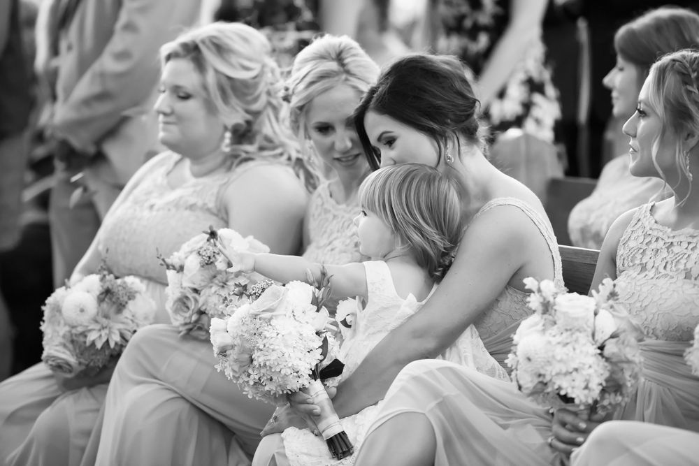 Flower girl watches wedding ceremony at Saint Mary Parish in Elyria, Ohio.