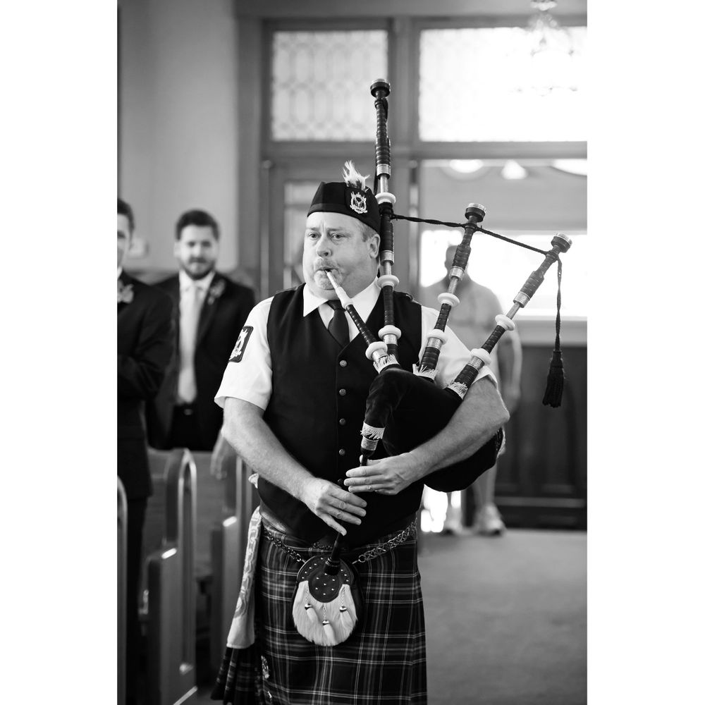 Bagpiper plays during wedding recessional at Saint Mary Parish in Elyria, Ohio.