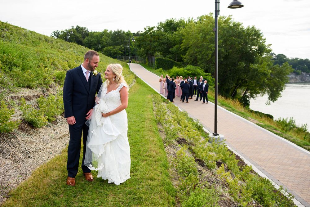 Bride and groom walk near Solstice Steps in Lakewood, Ohio.