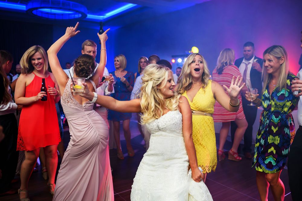 Bride having a blast on dance floor during her wedding reception at Emerald Event Center in Cleveland, Ohio.