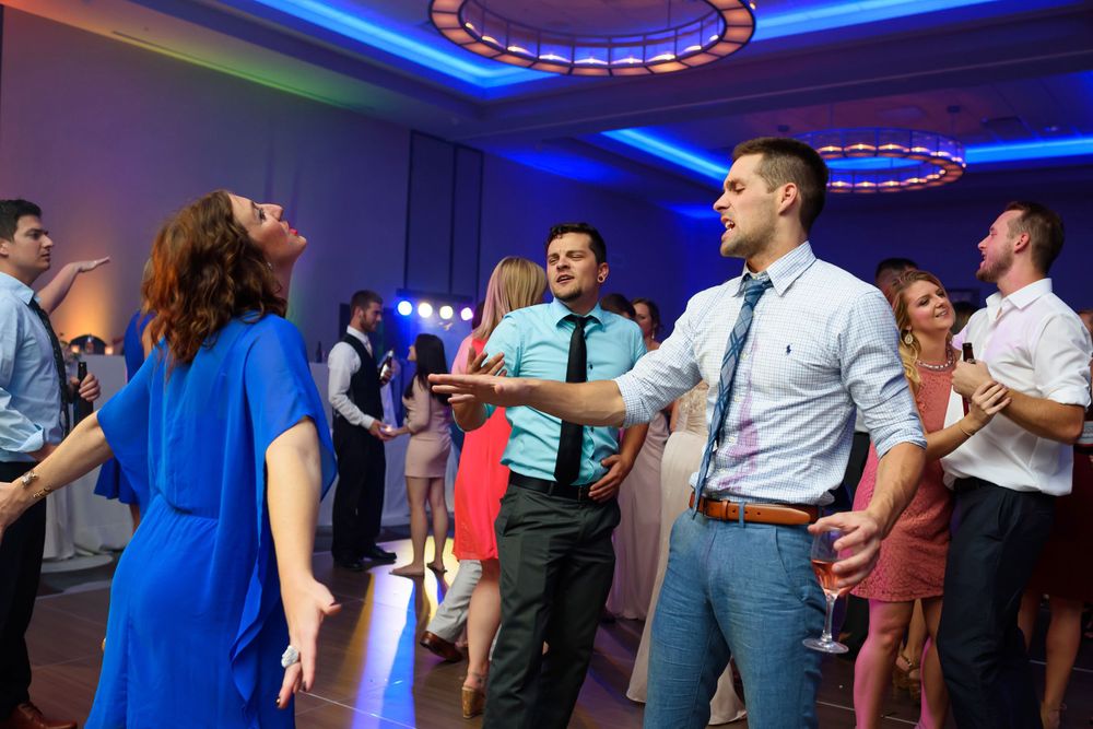Guests letting loose on dance floor during lively wedding reception at Emerald Event Center in Cleveland, Ohio.