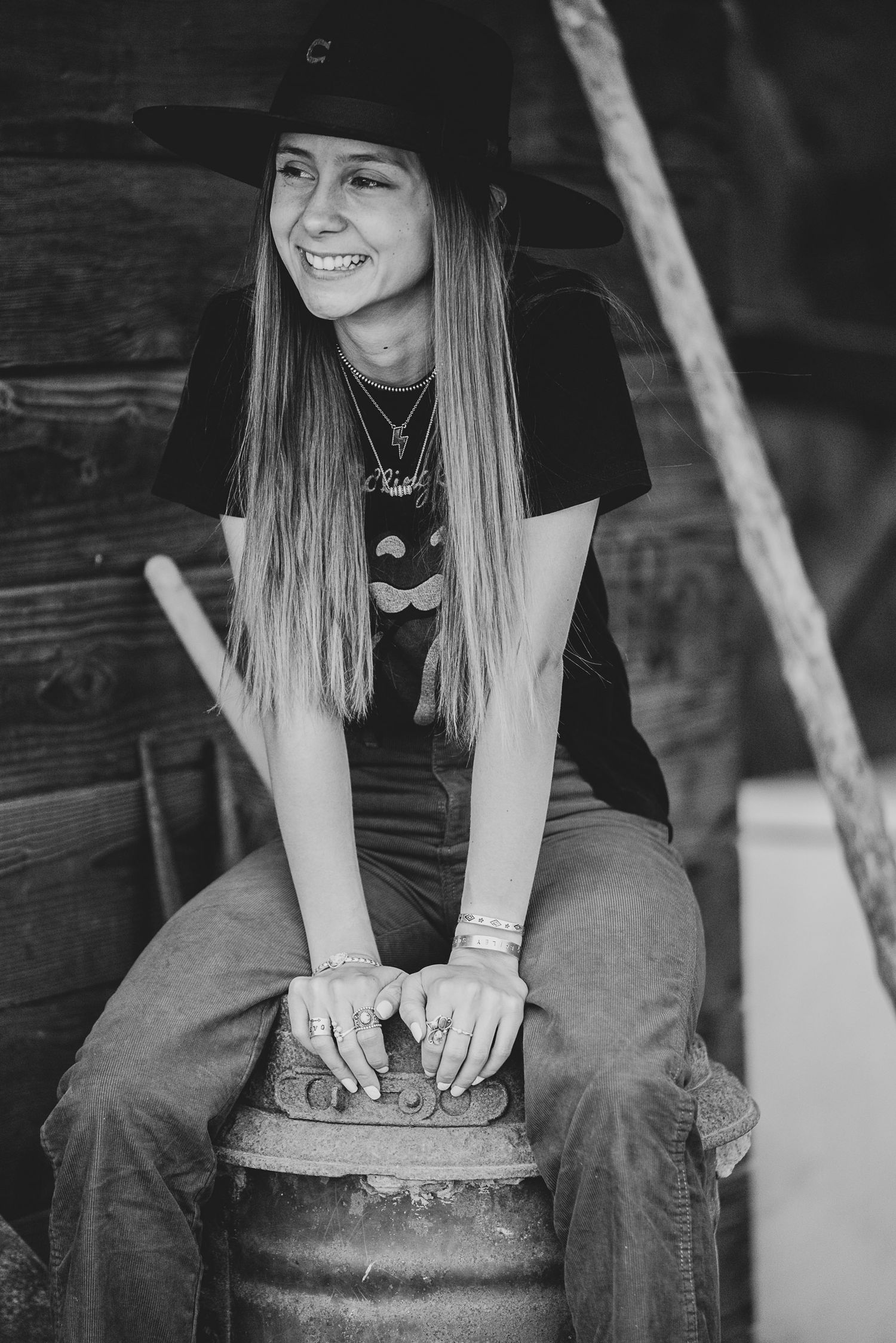 Black and white series showing casual poses on rustic wooden bench.
