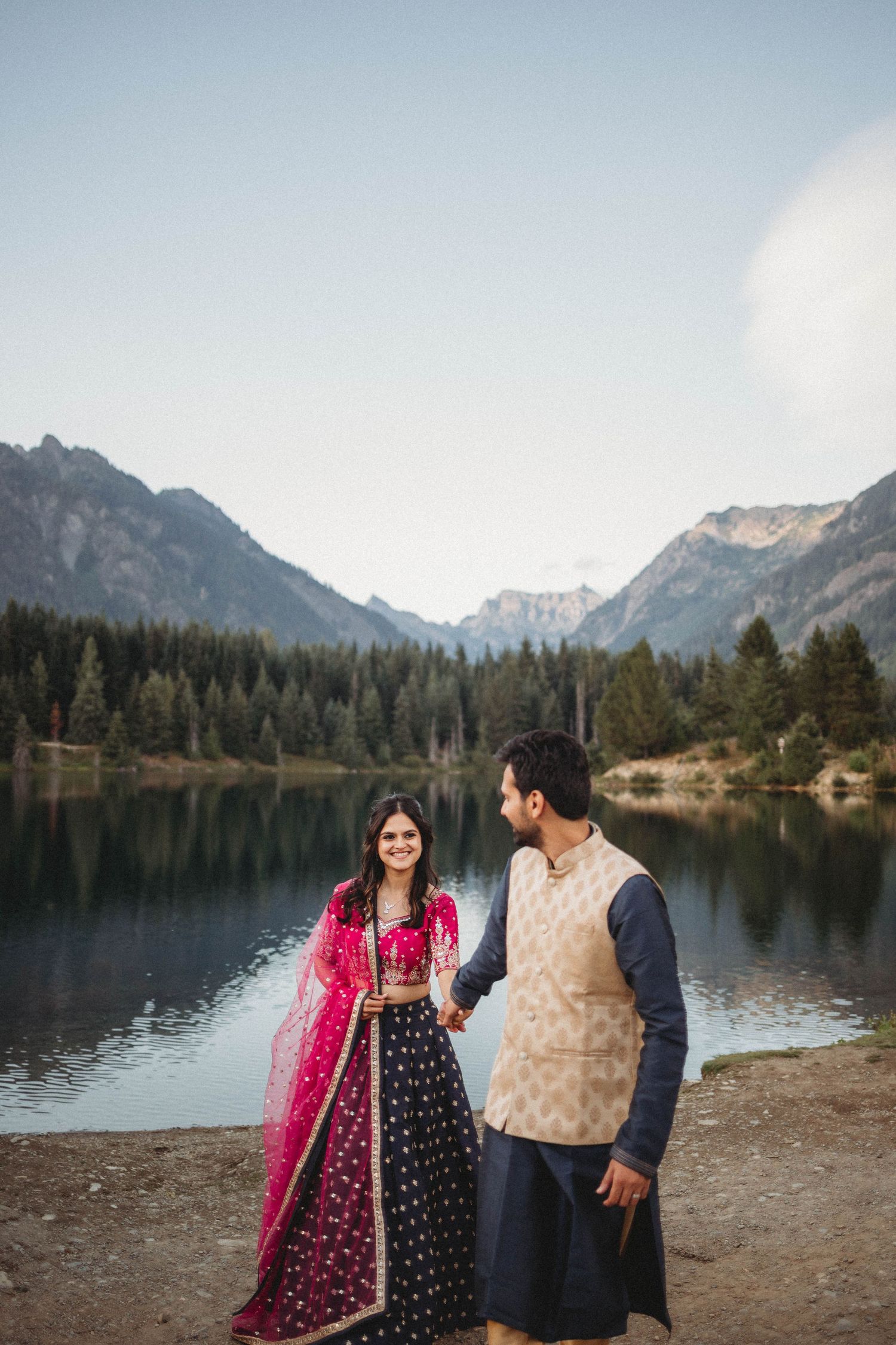 A bride and groom are walking together at Gold Creek Pond on their elopement day.