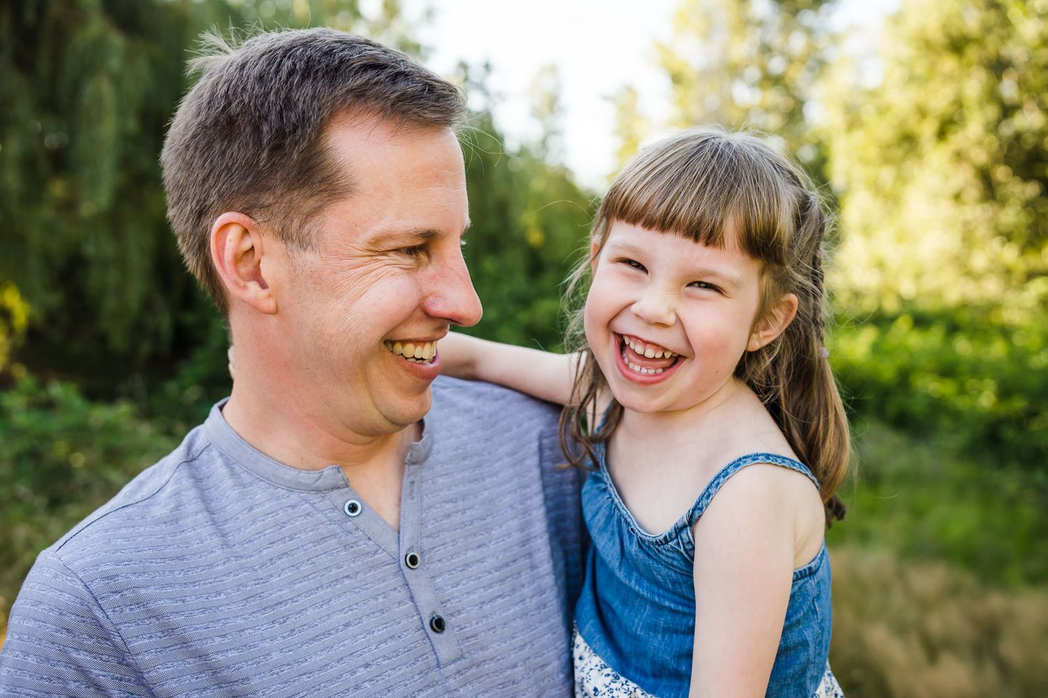 Father daughter smiling in Juanita Bay Park.