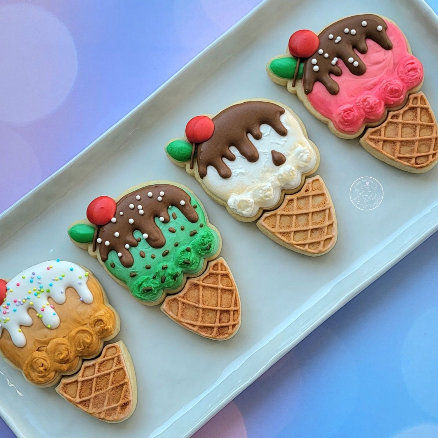 Close-up of decorated sugar cookies shaped like ice cream cones, each topped with colorful scoops and dripping icing.