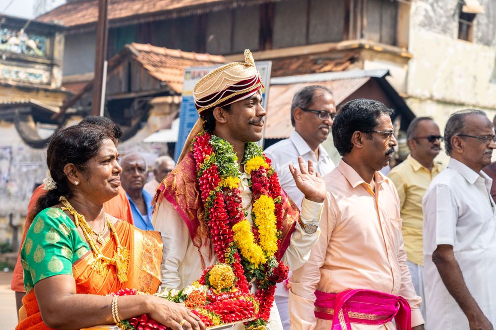 Festive celebration with colorful traditional attire and garlands during a South Indian wedding ceremony.