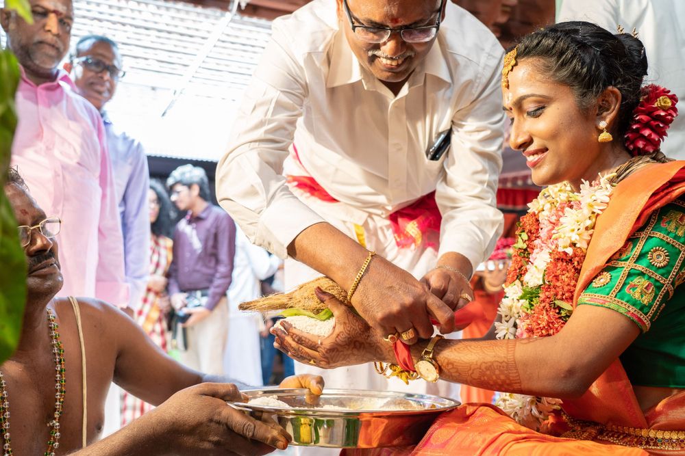 Traditional South Indian wedding ceremony with ritual offerings and blessings being performed.