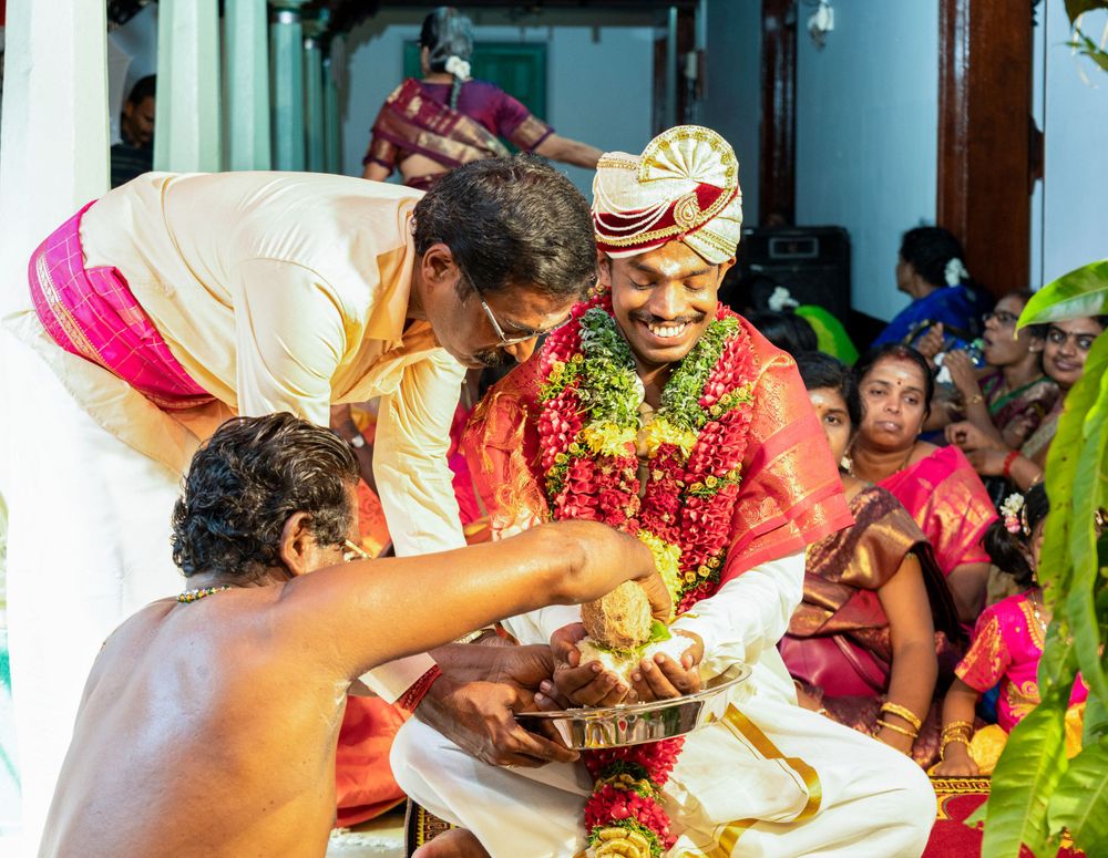 Traditional ceremony showing ritual offering exchange with flower garlands and colorful decorations.