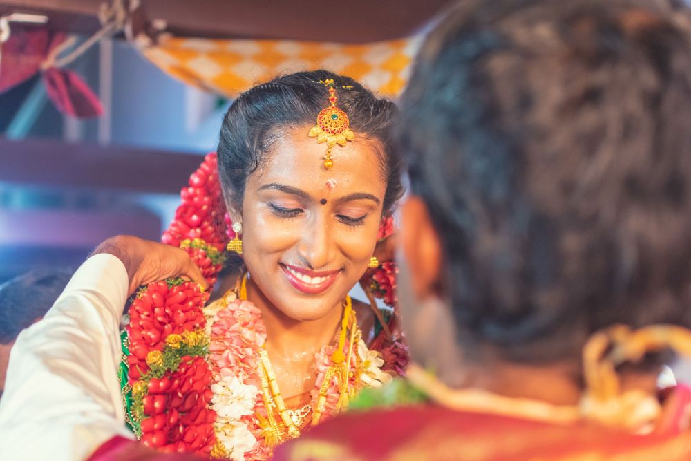Traditional South Indian wedding ceremony with bright floral garlands and celebratory decorations.