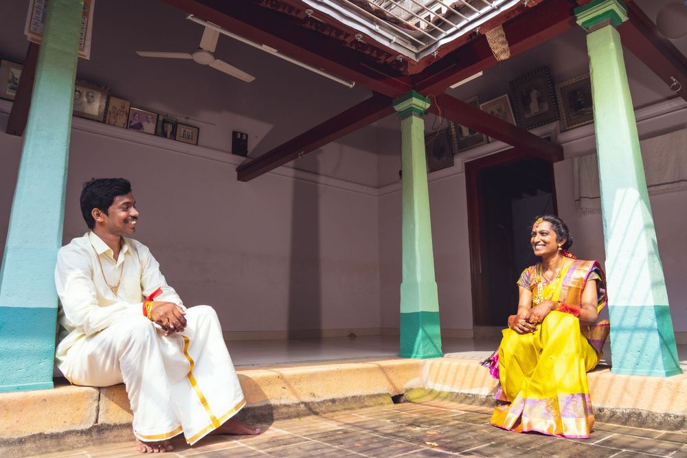 Traditional Kerala style portrait in courtyard with mint green pillars and formal attire.