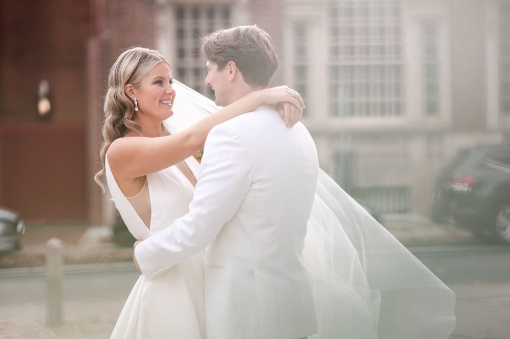 Romantic wedding moment captured in an urban setting with soft lighting.