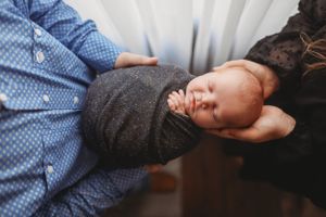 A tender family portrait session showing gentle interactions in soft lighting.