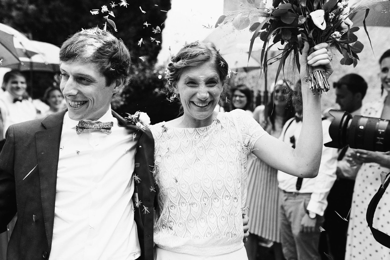 Black and white vintage photo of happy newlyweds celebrating outdoors.