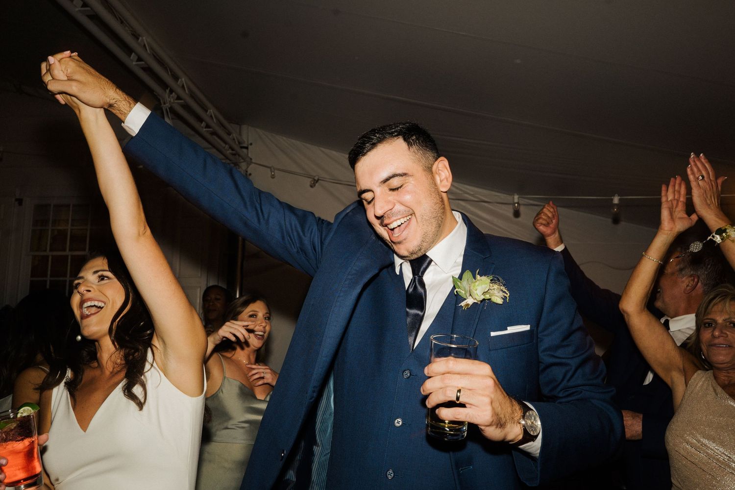 Celebration erupts on the dance floor during a joyous wedding reception.