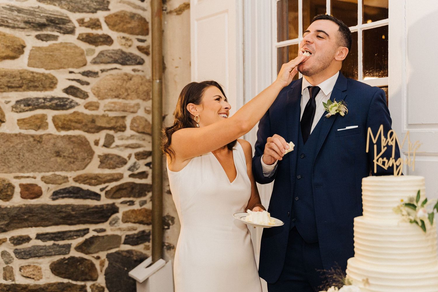 Playful moment as newlyweds share cake during their wedding reception.
