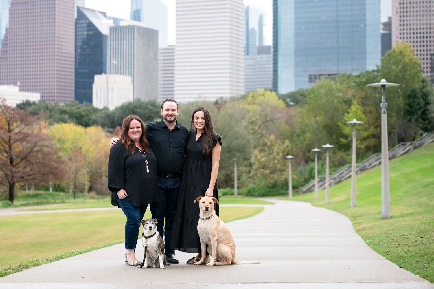 Family with dogs in front of Houston Skyline
