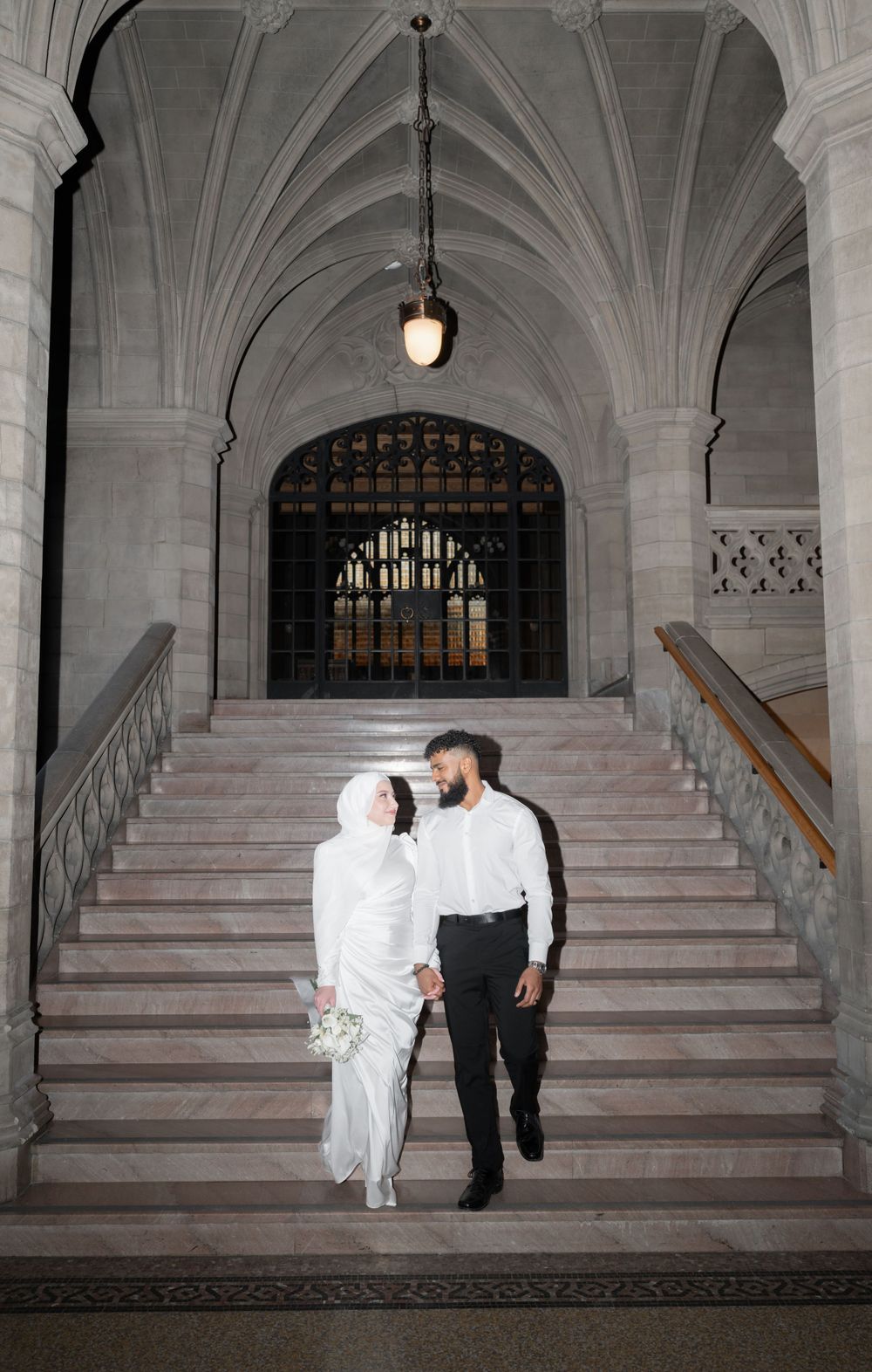 Couple posing for wedding engagement photos in historic Toronto building