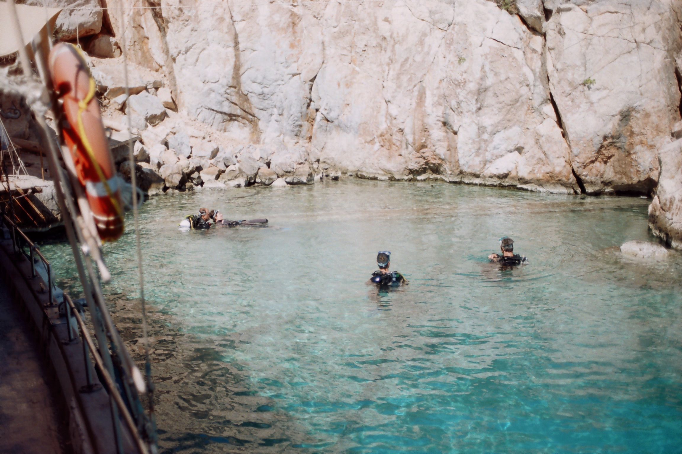 Stunning travel film capturing the beauty of a turquoise cove sheltered by tall white rocks, taken in Greece
