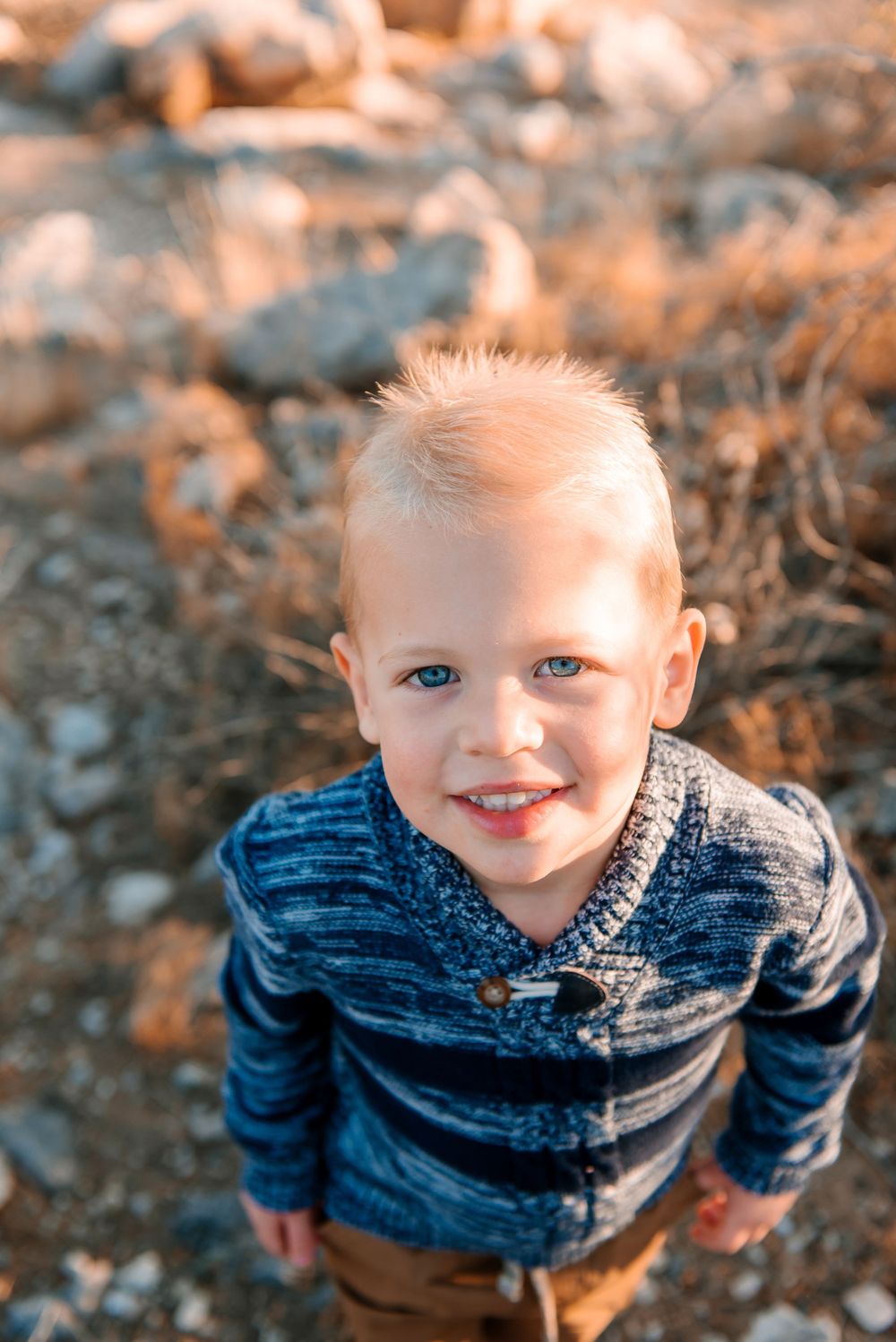 Close-up portrait in desert setting with warm sunset lighting.