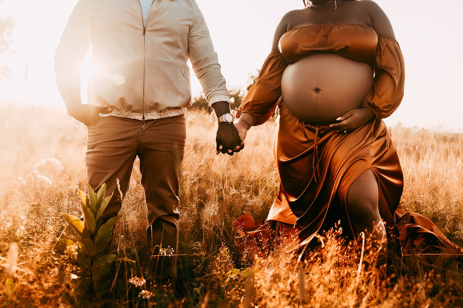 A couple hold hands during their maternity photoshoot in Shenandoah National Park.