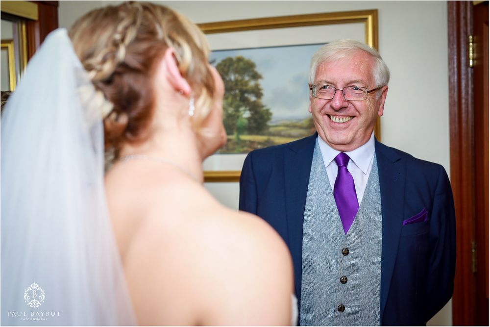 An emotional moment captured during wedding preparations shows a touching interaction.