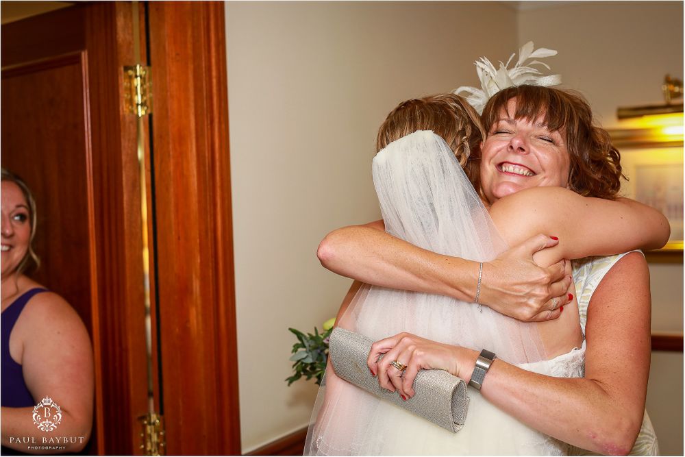 Two people sharing a warm embrace during a wedding celebration.