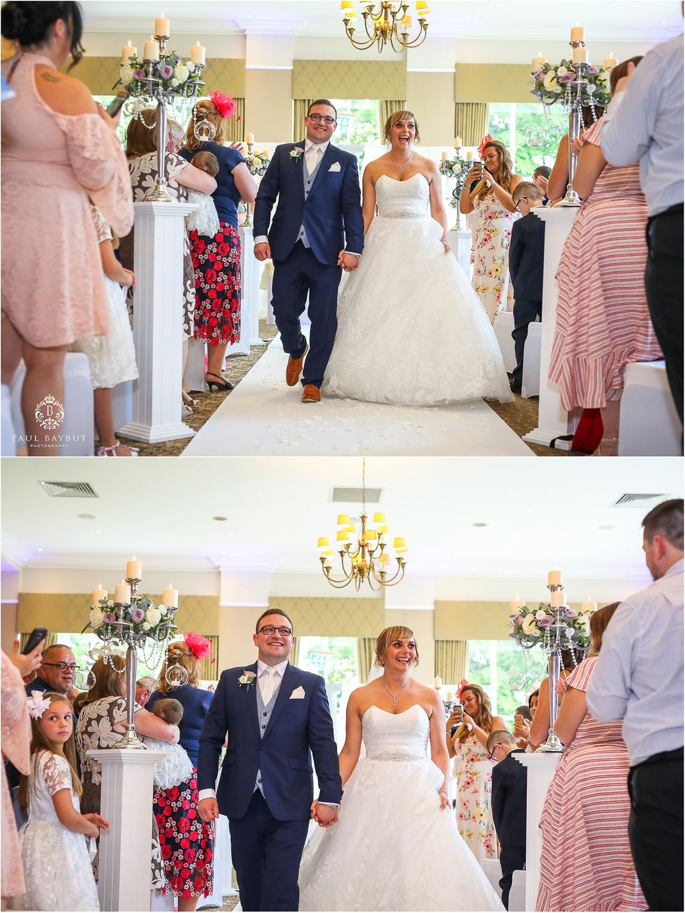 Wedding couple making grand entrance through aisle lined with guests and elegant chandeliers.