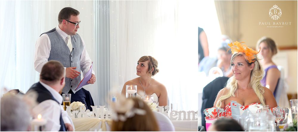 Wedding reception guests listening attentively to a speech in an elegant indoor setting.