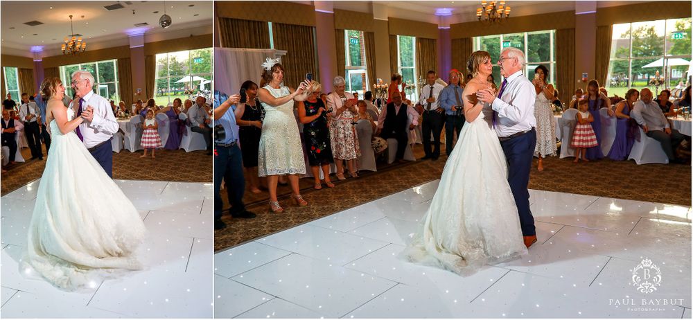 Wedding couple shares their first dance on white floor at indoor reception.