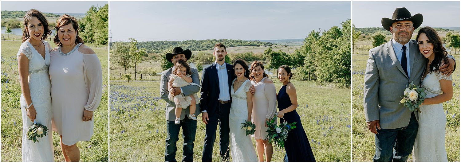 Wedding party poses together in a sunlit field on a beautiful spring day.