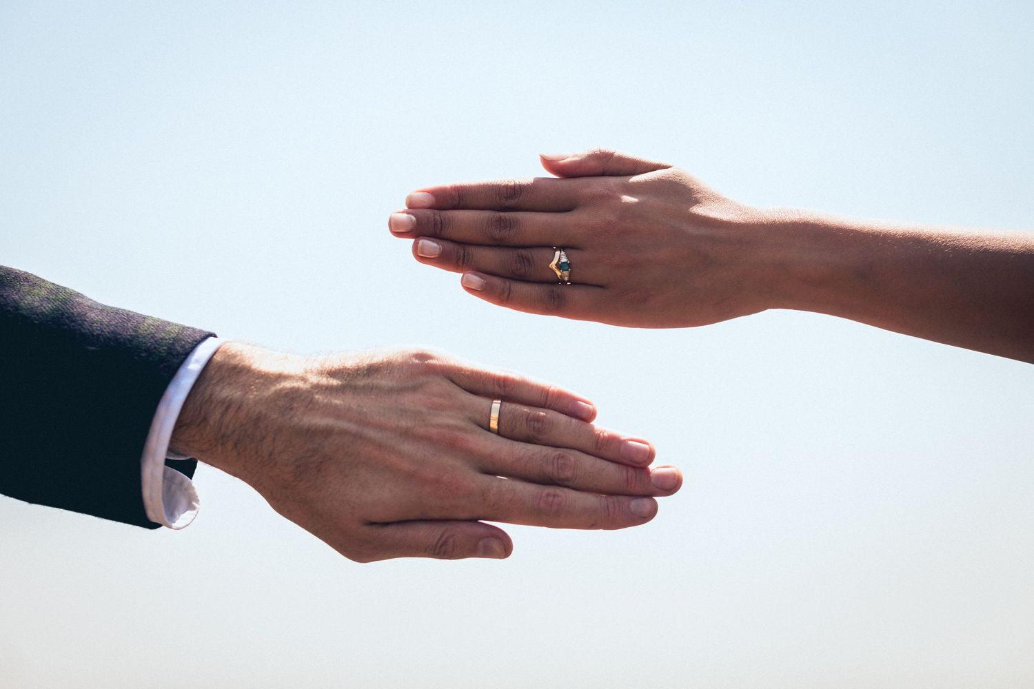 Close-up series of hands with wedding rings showing matrimonial connection against white background.