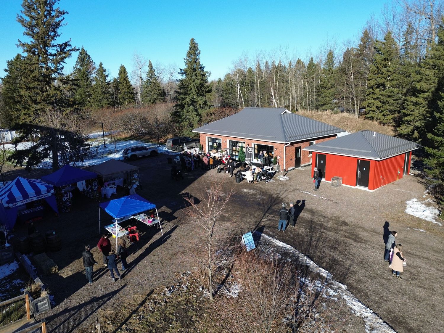 Winter venue with brick building and red storage unit showing outdoor gathering space.